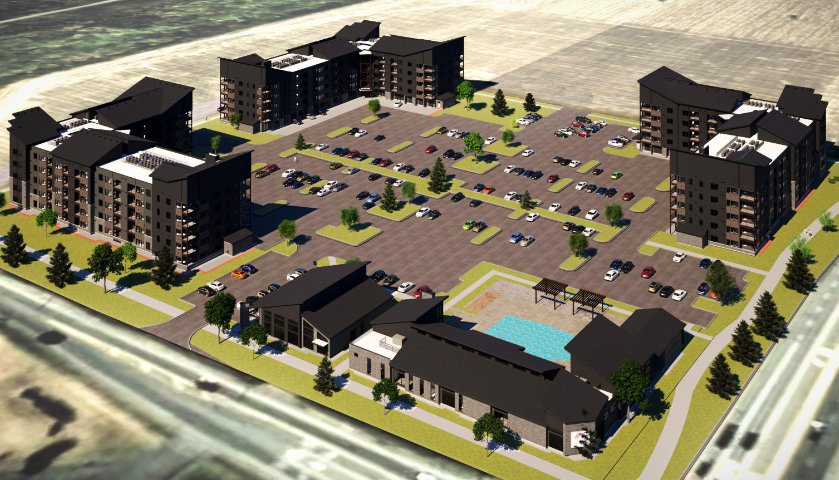 Aerial view of multifamily investment property with landscaped grounds and organized parking layout.