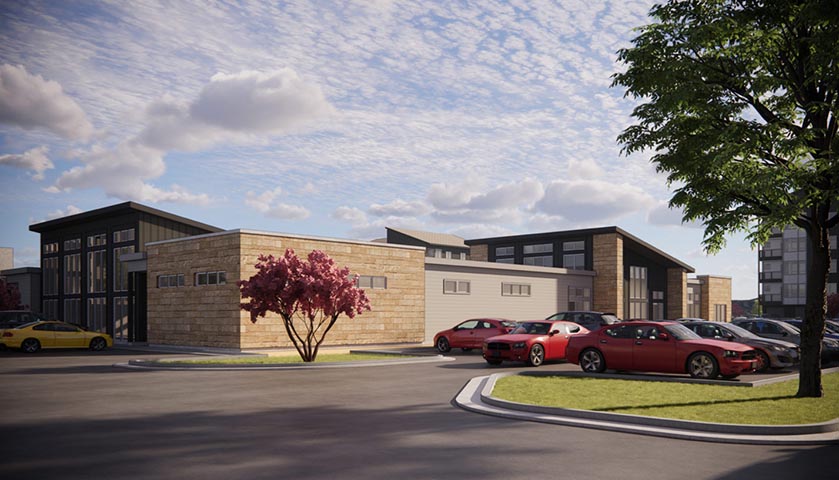Modern multifamily investment property with wood and dark facade, parking lot, and landscaping under blue sky.